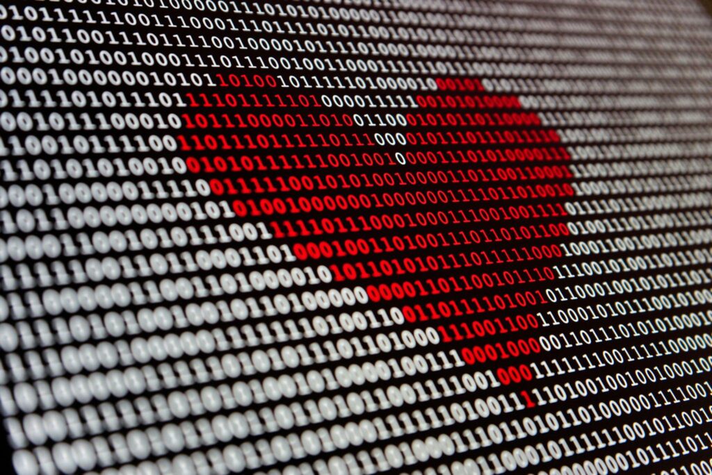 closeup of a red heart made up of binary 1 and 0