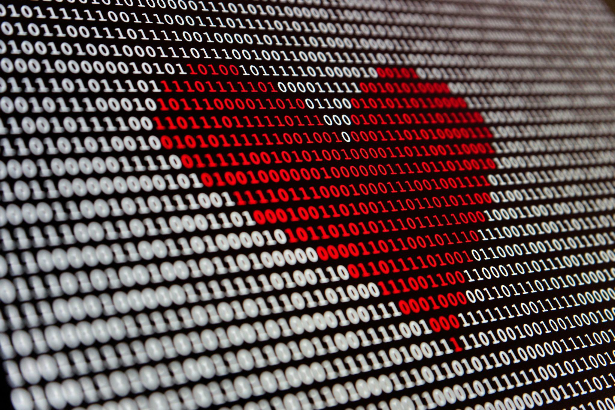 closeup of a red heart made up of binary 1 and 0