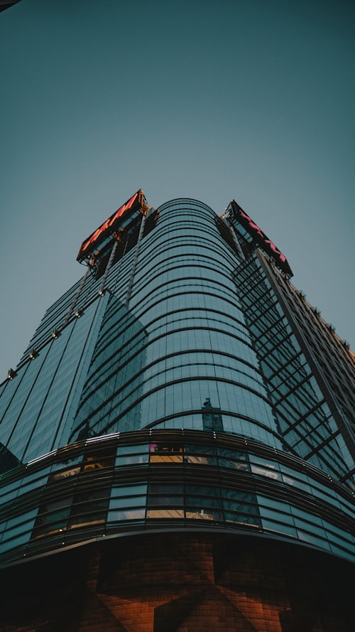 exterior glass office building looking up from street level
