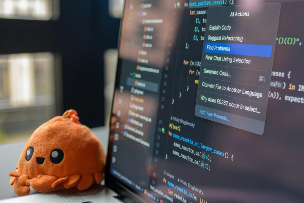 closeup view of monitor highlighting "find problems" with a small crab stressball on the desk next to it