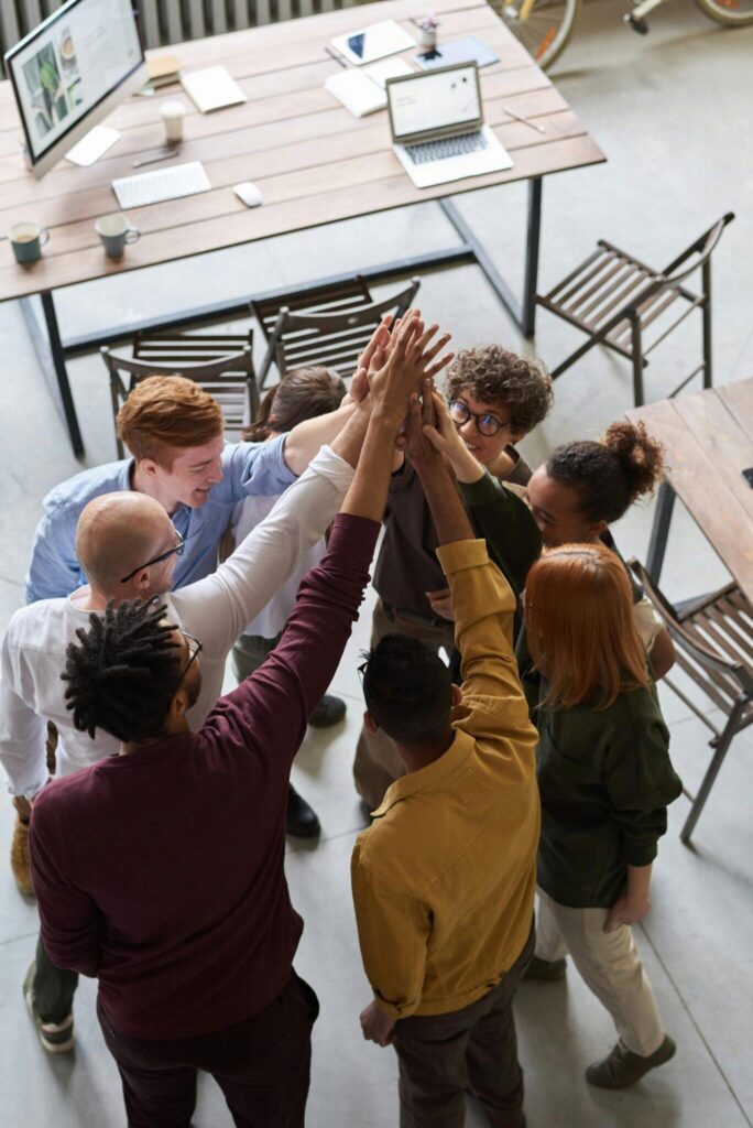 overhead group image of team giving a collective high-five