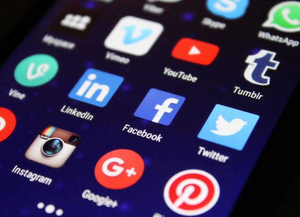 closeup of mobile phone display with social media app icons