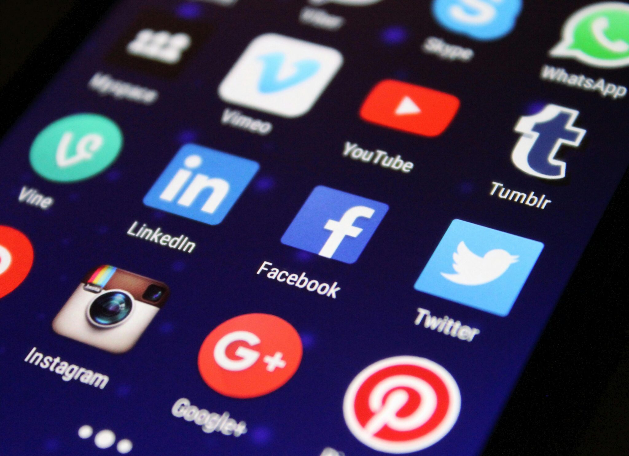 closeup of mobile phone display with social media app icons