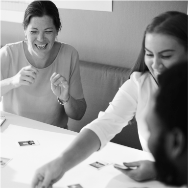 black and white image of women holding cards